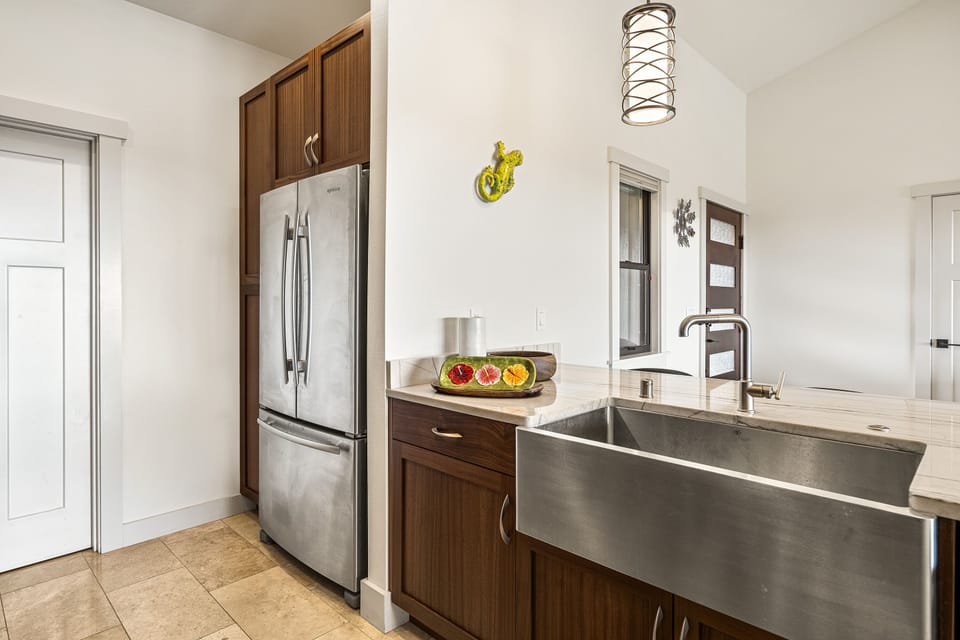 Kitchen with sink and fridge.