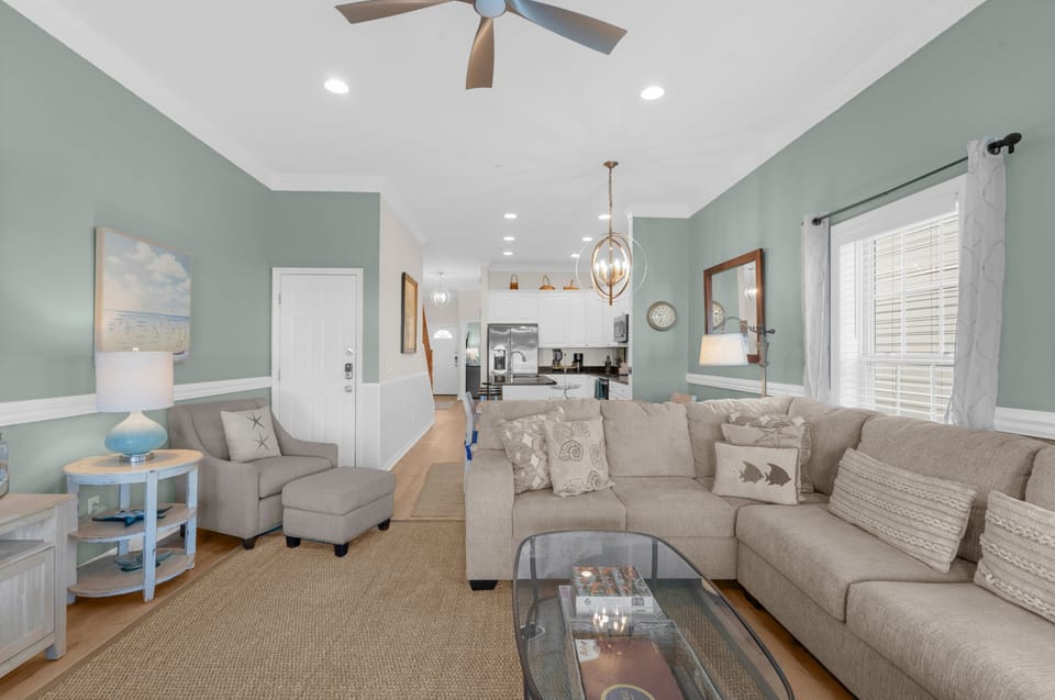Another view of the open-concept living space, showcasing its expansive layout and comfortable seating, ideal for gathering and unwinding.