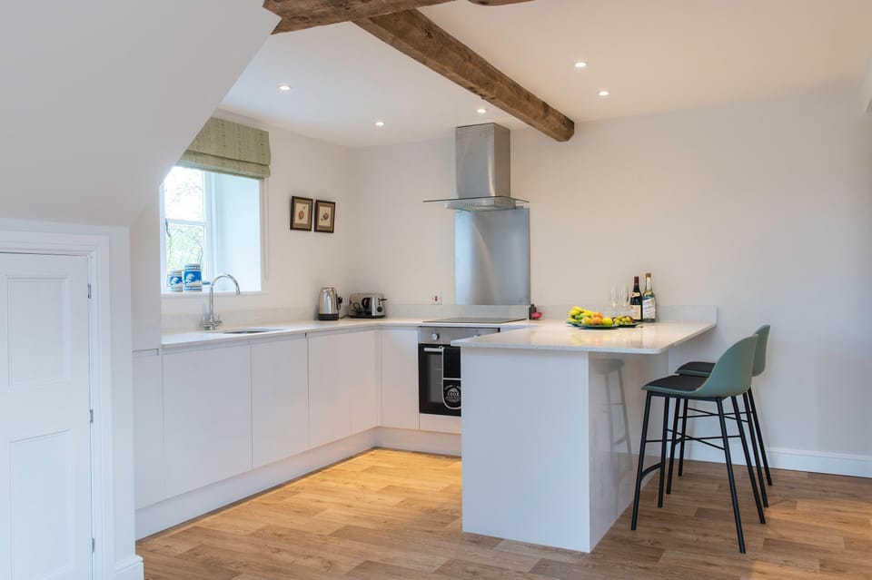 Ground floor: Open plan kitchen with breakfast bar and stools