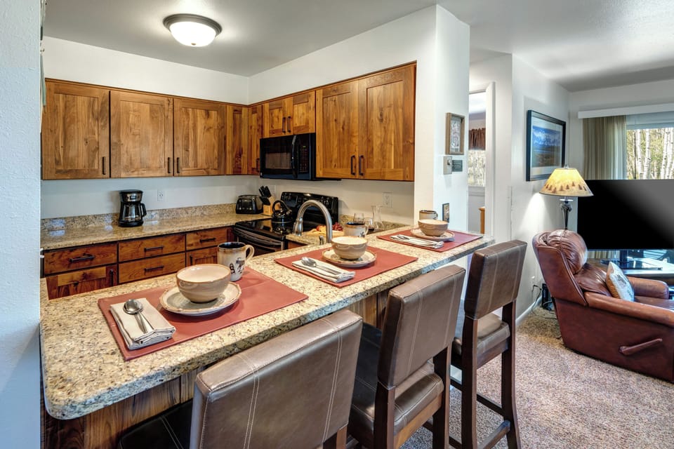 The kitchen includes gorgeous wood cabinets and stainless steel appliances