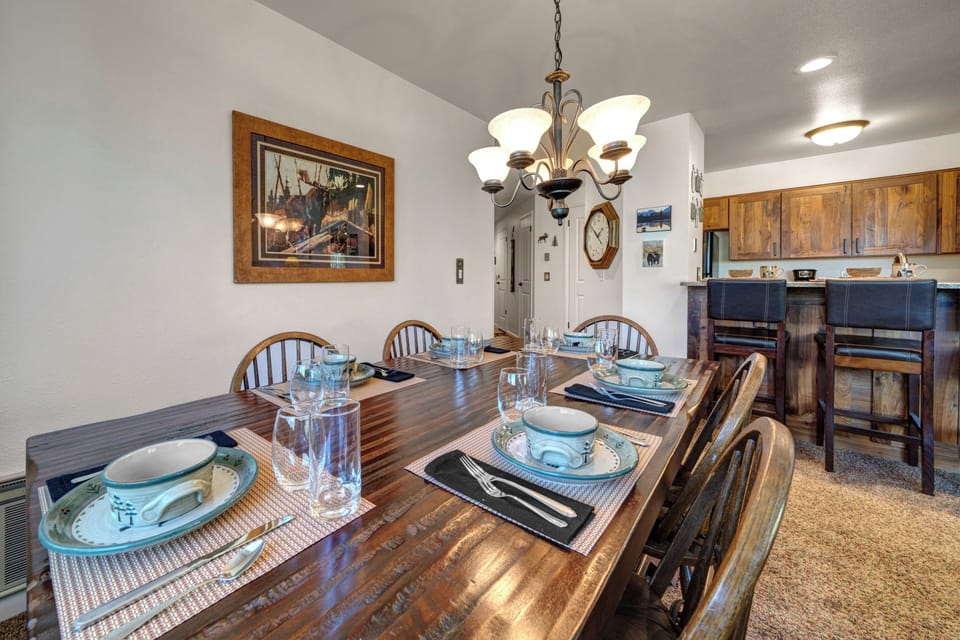 The dining room table offers seating and place settings for six guests.