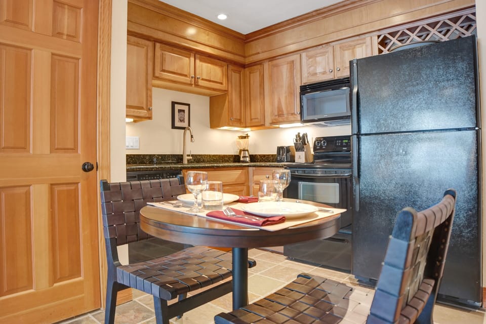 The kitchen features beautiful wood cabinets and green granite countertops