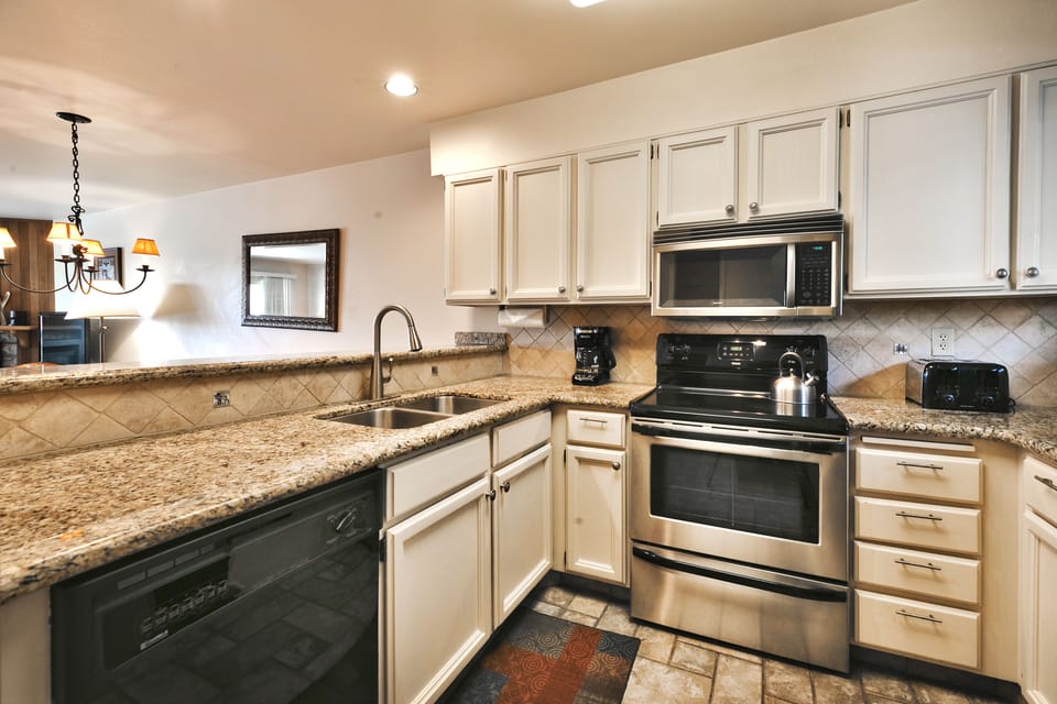 The kitchen offers a bar area for seating to look into the dining area and living room
