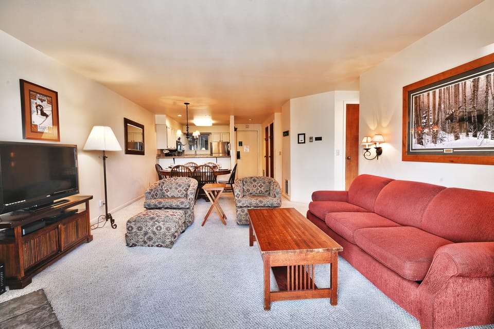 The living room with open floor plan into the dining area and kitchen