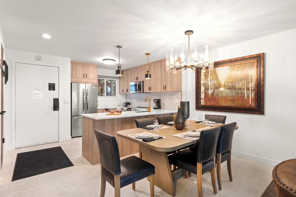 The dining table offers seating for 6 guests and has a gorgeous modern chandelier.
