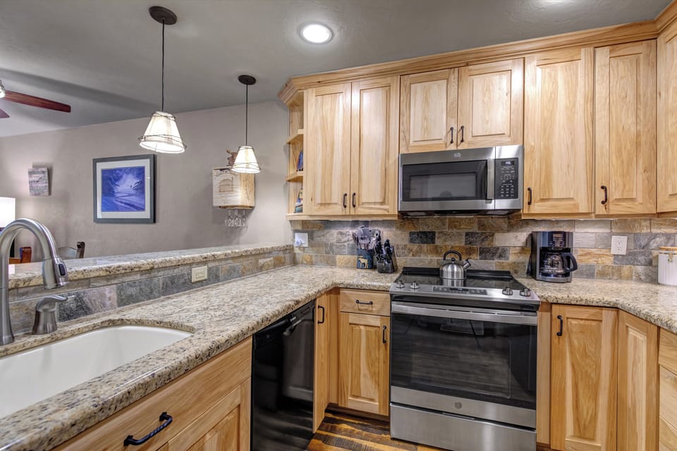 The kitchen offers a spacious breakfast island and large prep surface.