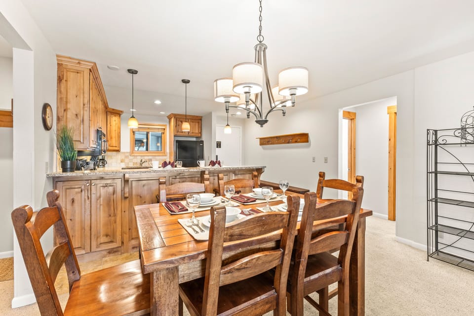 Snow Flower Condominium 14's dining area with seating for 5 and an open concept kitchen.