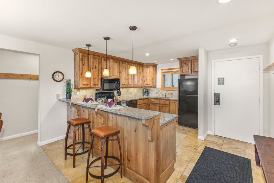 Snow Flower Condominium 14's open concept kitchen with a breakfast bar and seating for 2.