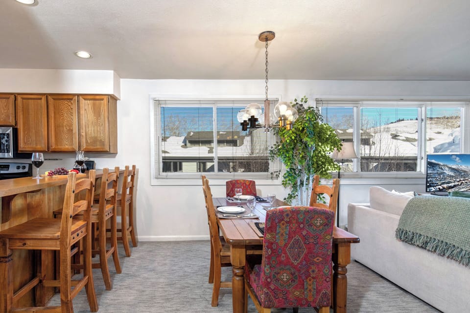 The dining area with seating for four and breakfast bar with seating for three.