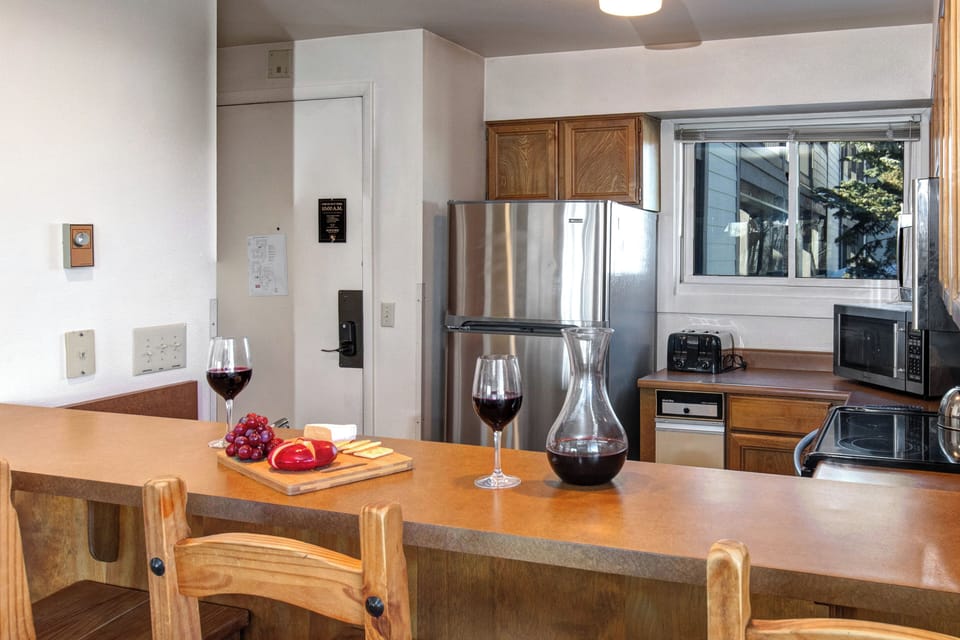The well-equipped kitchen offers a breakfast bar and stainless steel appliances.