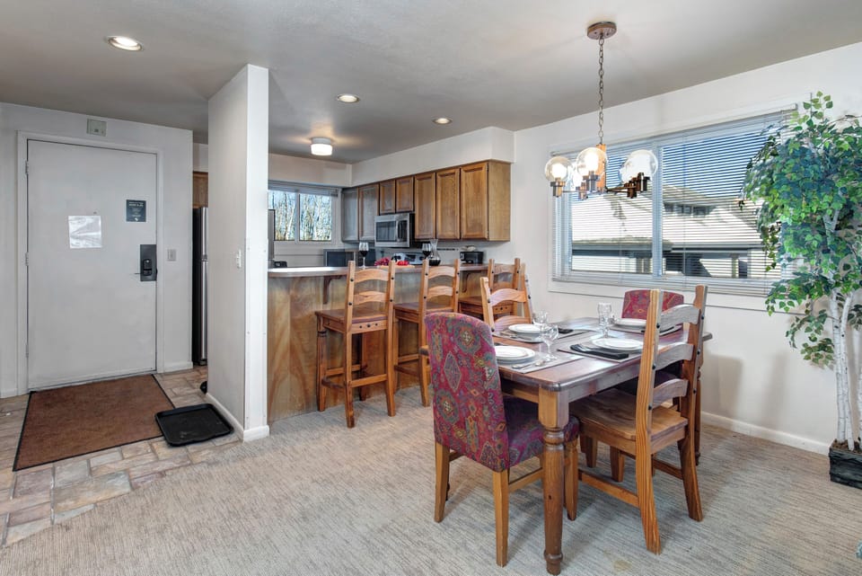 The dining area with seating for four and breakfast bar with seating for three.