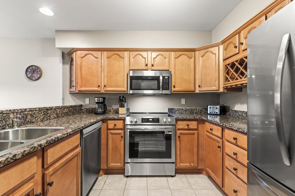 The well-equipped kitchen with new stainless steel appliances.