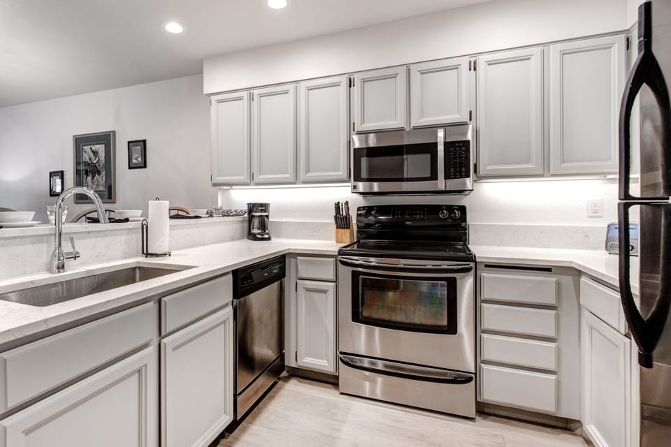 Snow Flower 152 has a well equipped kitchen with grey cabinets and stainless steel appliances.