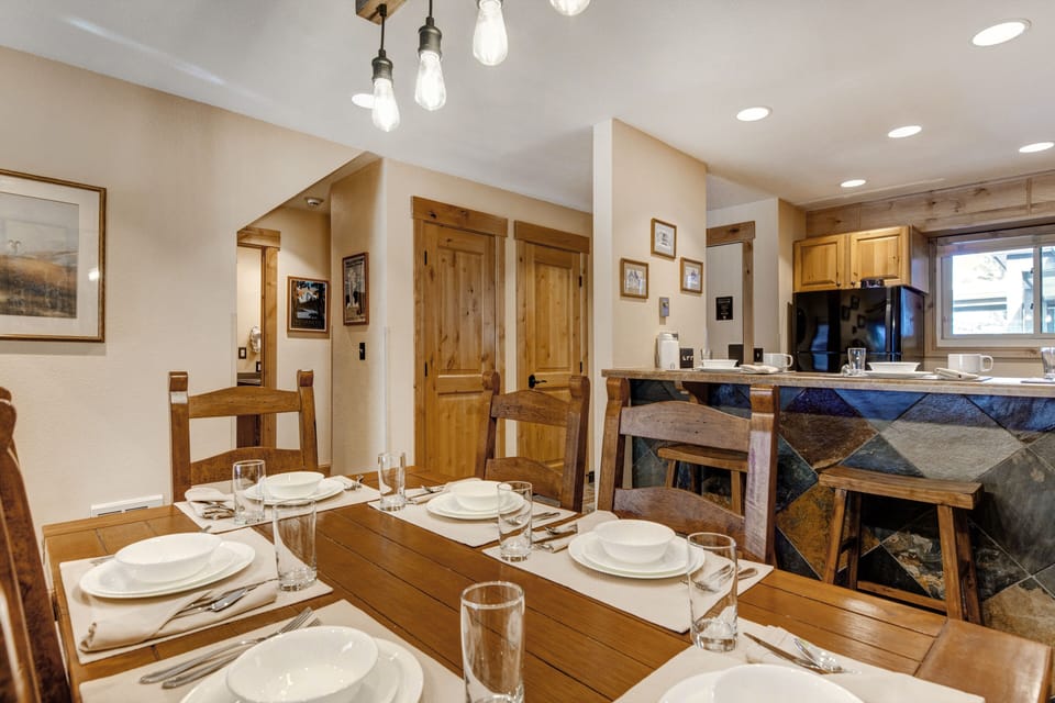 The dining table offers seating for 6 and crisp white dinnerware.