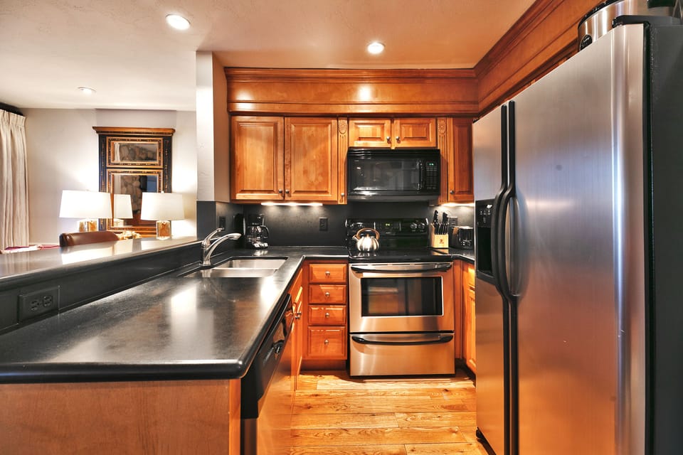Kitchen includes solid wood cabinets and stainless steel appliances