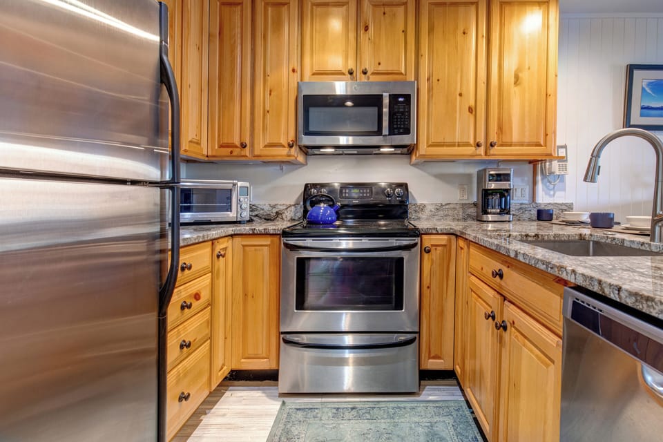 Snow Flower 30 offers an open concept kitchen with wood cabinets and stainless steep appliances.