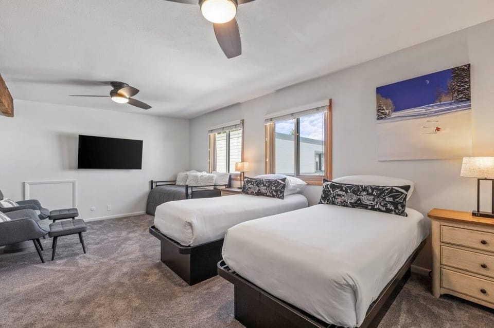 The loft with a twin size day bed, two twin size beds, and a sitting area.