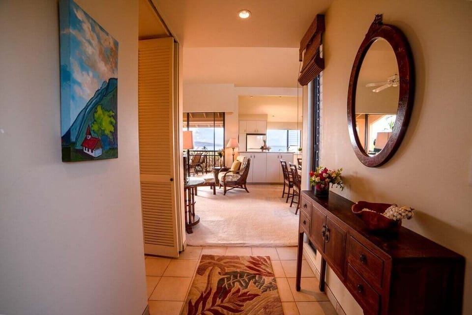 Walk hallways styled with mirrors, flowers, and art.