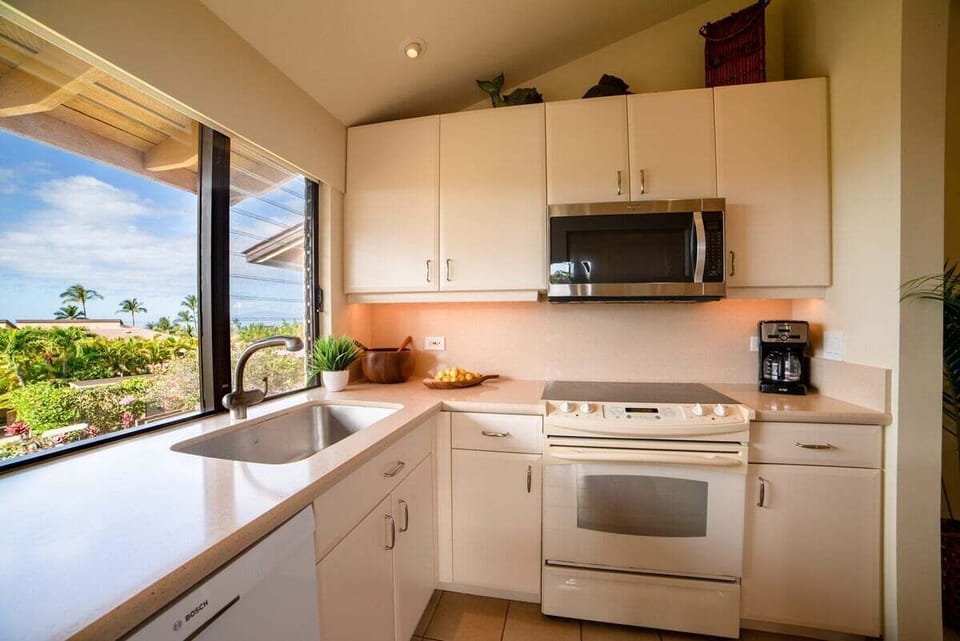 Cook in bright kitchens where windows frame palms and sky.