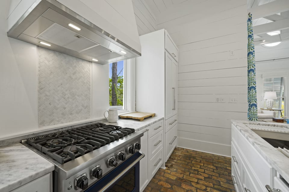 4 BURNER GAS STOVE AND LARGE CUSTOM BUILT IN FRIDGE