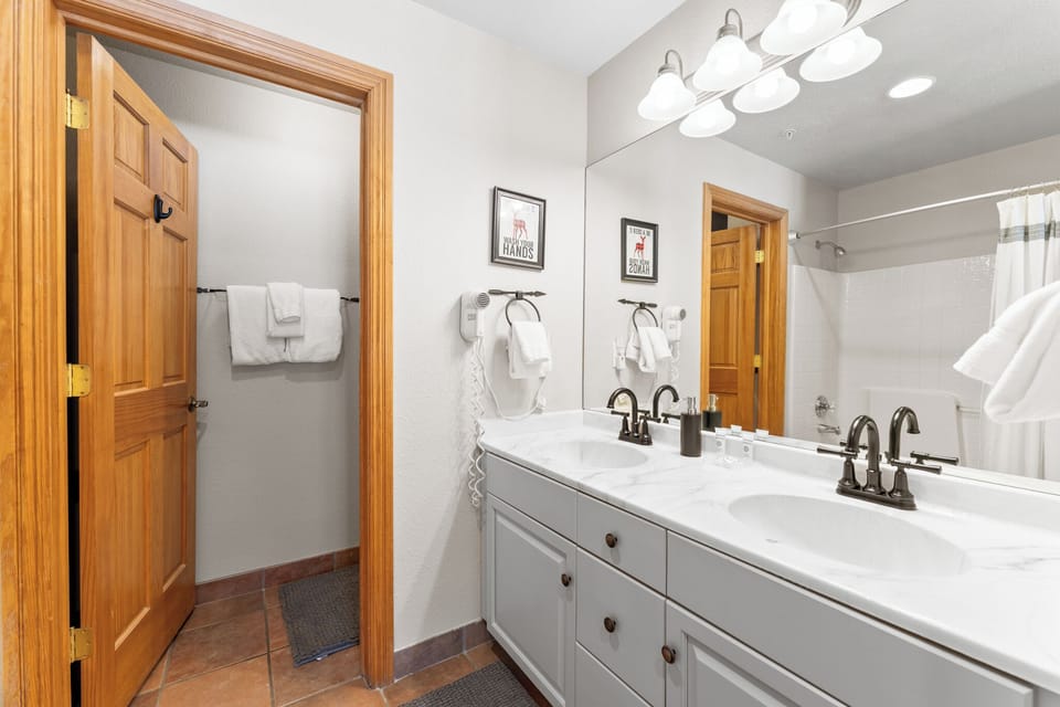 Step into your spacious bathroom with dual sinks, perfect for getting ready together. Fresh towels and thoughtful touches await your arrival.