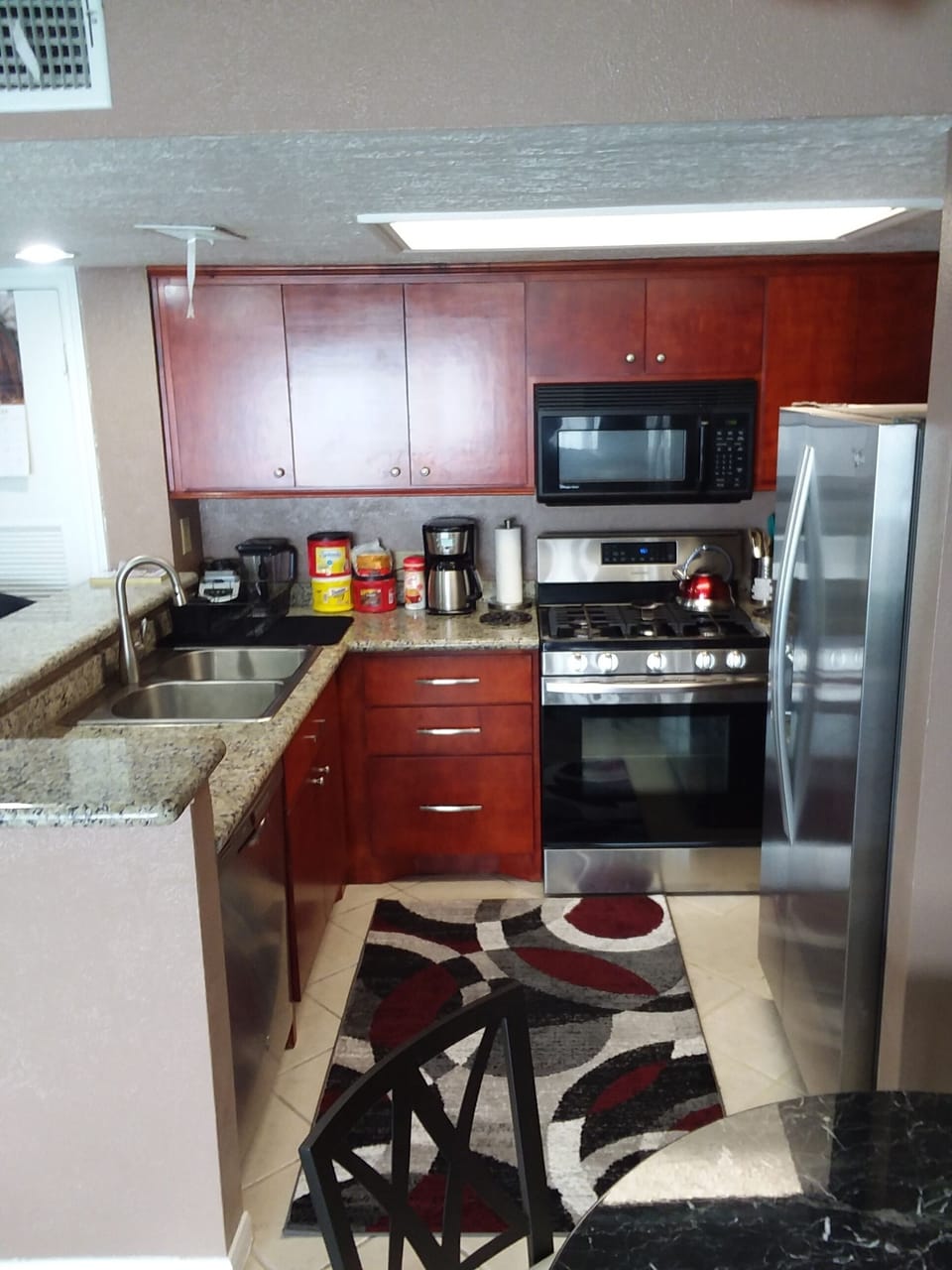 Kitchen with all stainless appliances.  View 1
