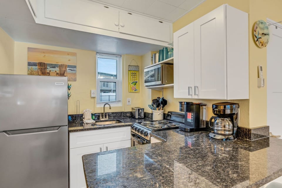 The kitchen is equipped with basics for convenience. It Includes a refrigerator, stove/oven, microwave, toaster and a Keurig & regular drip coffee maker
