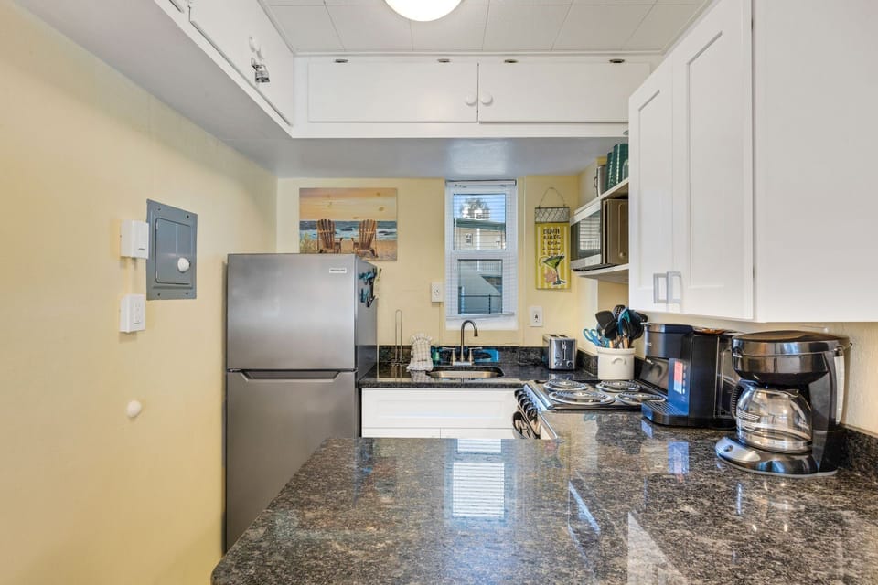 The kitchen is equipped with basics for convenience. It Includes a refrigerator, stove/oven, microwave, toaster and a Keurig & regular drip coffee maker