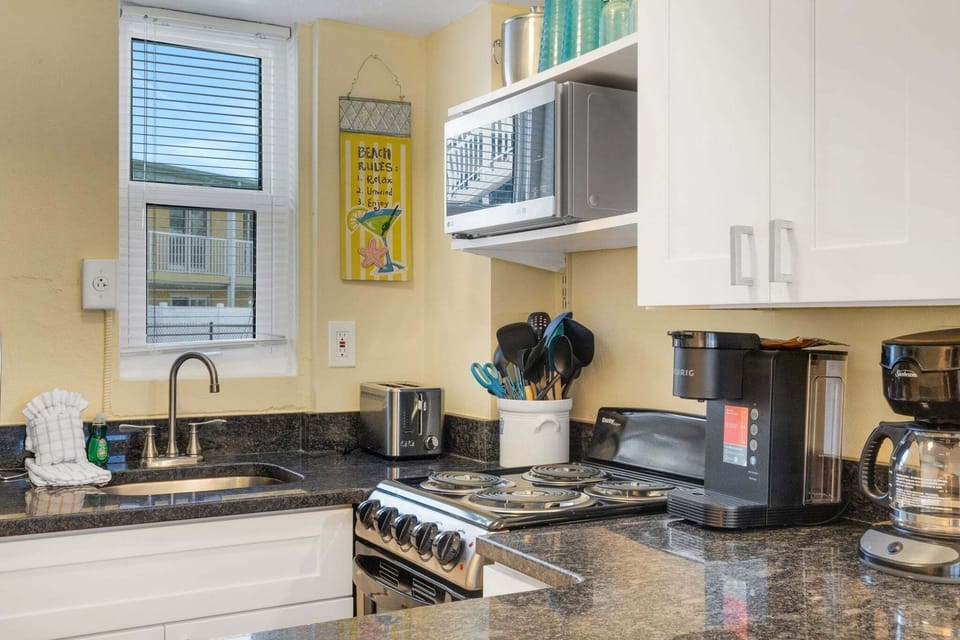 The kitchen is equipped with basics for convenience. It Includes a refrigerator, stove/oven, microwave, toaster and a Keurig & regular drip coffee maker