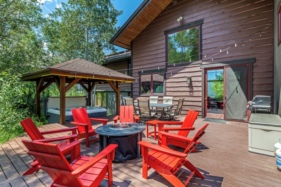 The spacious back deck invites you to dine al fresco, soak in the hot tub, or gather around the gas fire pit