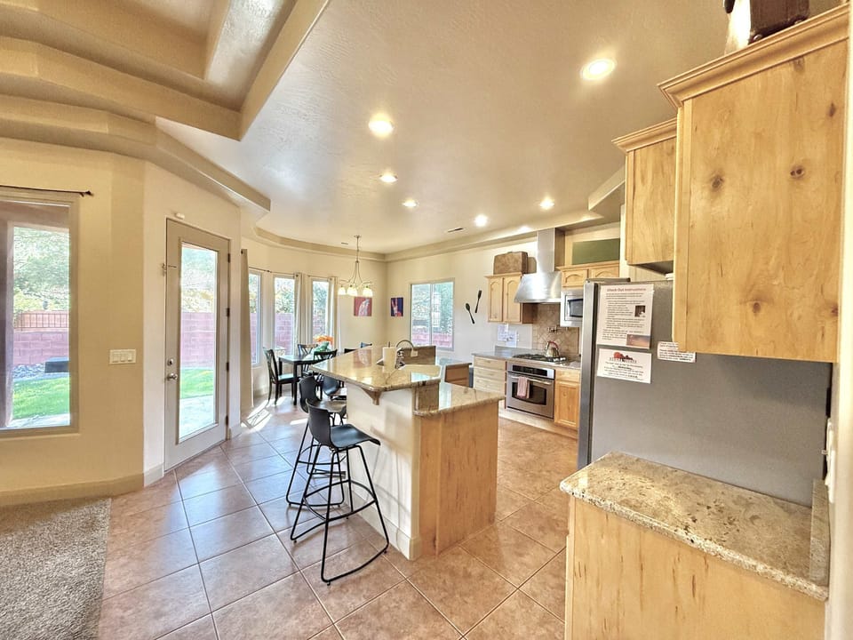 The fully appointed kitchen offers lots of large windows, plenty of cabinet and counter space, a dining area and extra seating at the bar.