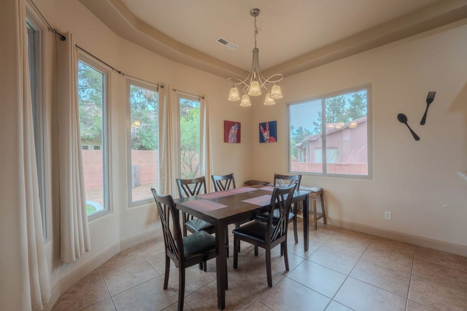 Bright breakfast nook with bay windows and seating for six at Spirit of the Rock, Kanab, UT.