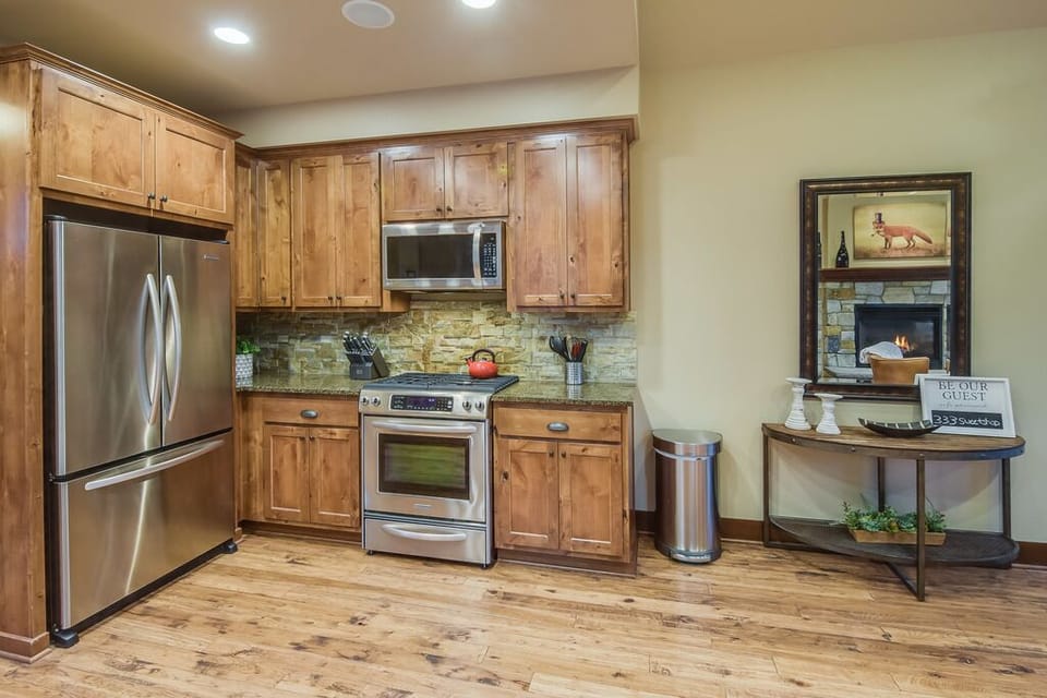 Fully equipped chef’s kitchen with stainless appliances and rich wood cabinetry