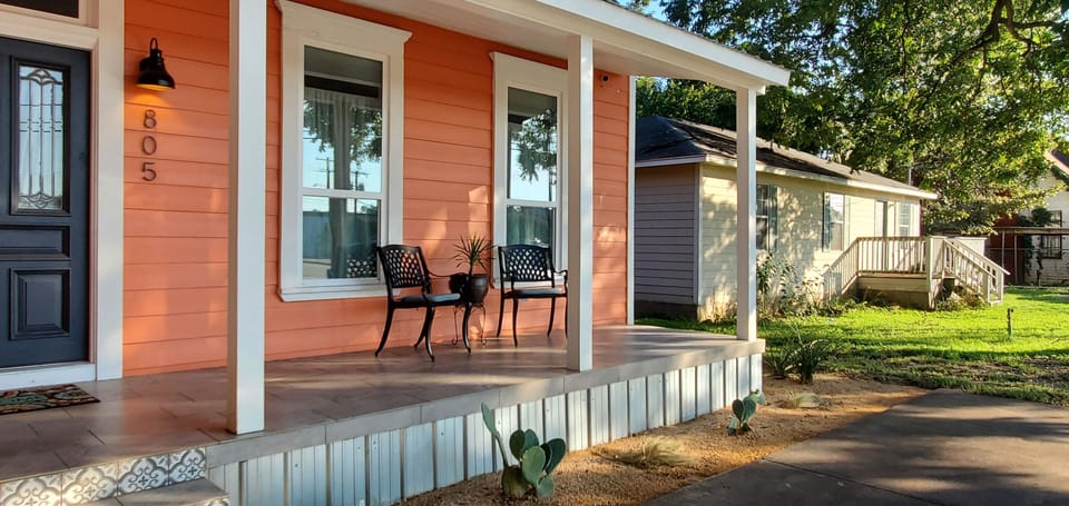 View of the front porch and charming farm house.