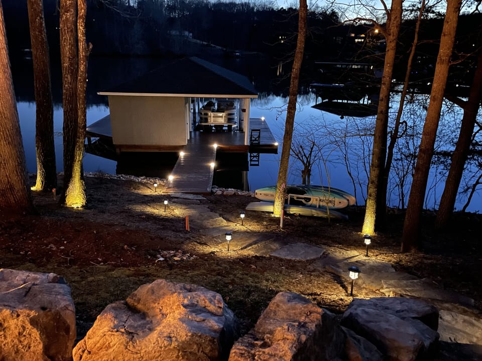 Night view of the dock/lake with gorgeous accent/landscape lighting