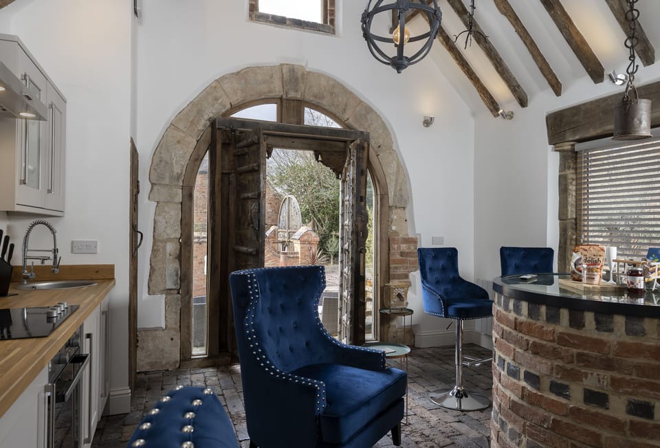 Ground floor: Open-plan living space with exposed beams and brickwork