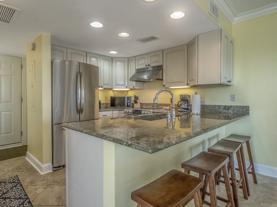 Once you walk through the front door you feel like you are home at the beach! The kitchen has breakfast counter seating with four stools.
