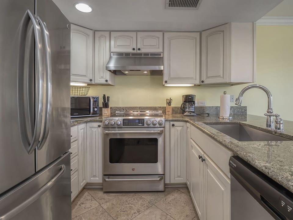 The kitchen has granite counter tops and stainless steel appliances.