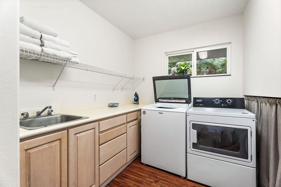 Laundry room makes extended stays effortless with full-size washer and dryer, plus counter space for folding.