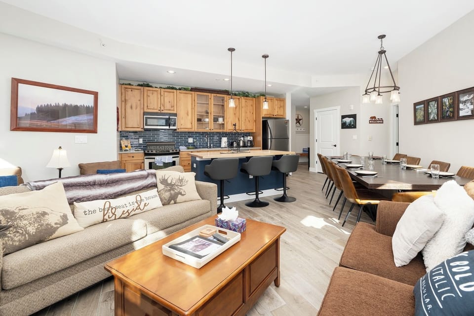 Open concept living, dining and kitchen area with views of the slope.