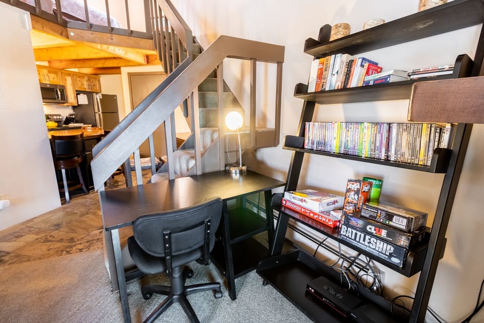 Computer desk, games, books, and video library.