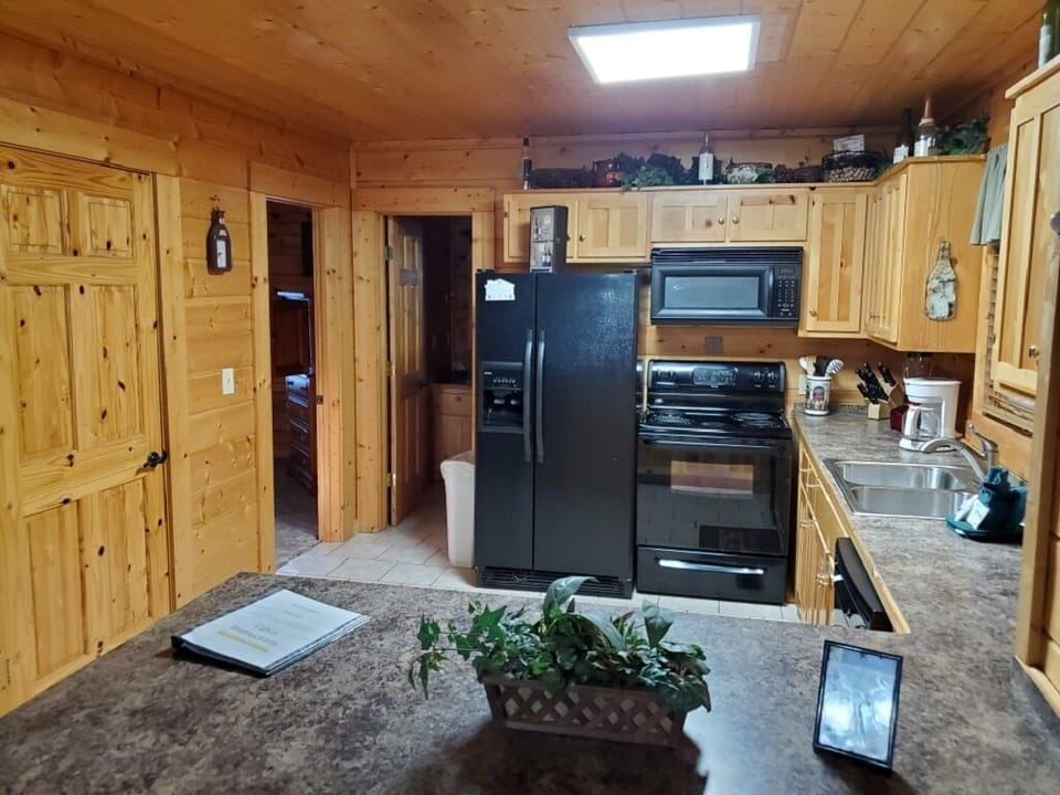 Kitchen includes side by side refrigerator, stove, microwave and dishwasher