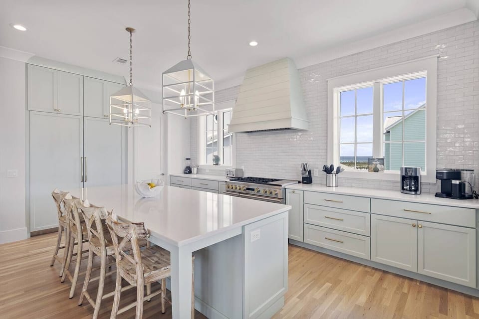 Spacious kitchen w/ a large island, bar seating & bright finishes.