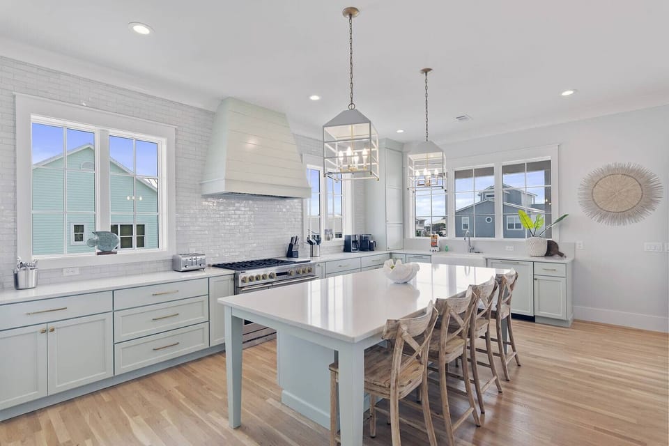 Open kitchen w/ a large island, bar seating & crisp modern finishes.