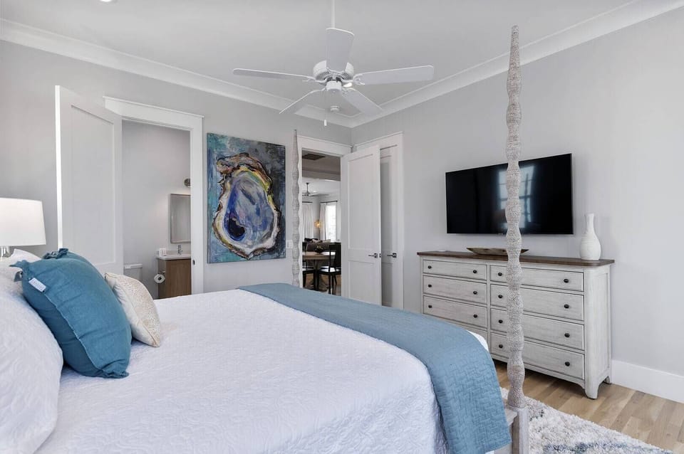 Relaxing bedroom w/ a comfortable bed & simple coastal decor.
