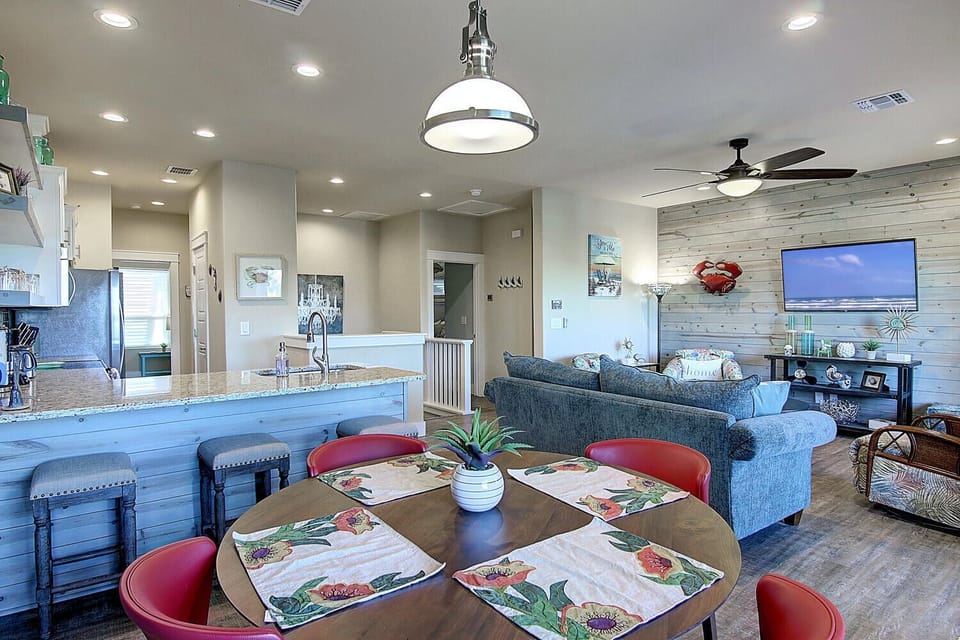 Relax in your stylish open-plan space where coastal charm meets modern comfort, with a fully equipped kitchen and cozy dining area.