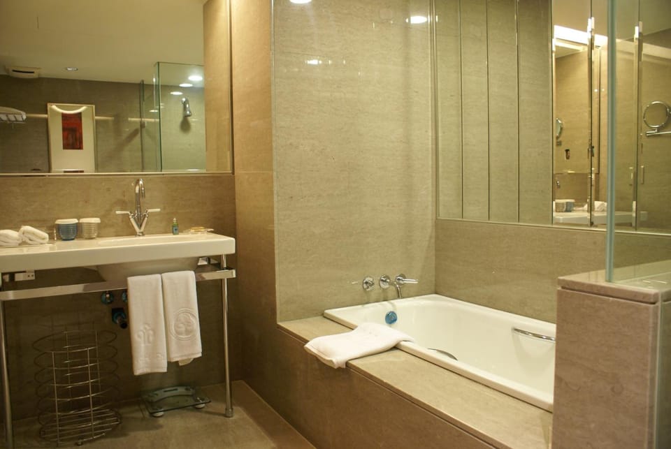 Separate tub and shower, hair dryer, slippers, towels