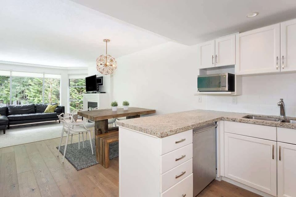 - Open kitchen overlooking dining and living area for seamless connection  
- Granite countertops and stainless details add modern mountain charm  
- Enjoy bright mornings with forest views right from the kitchen  

