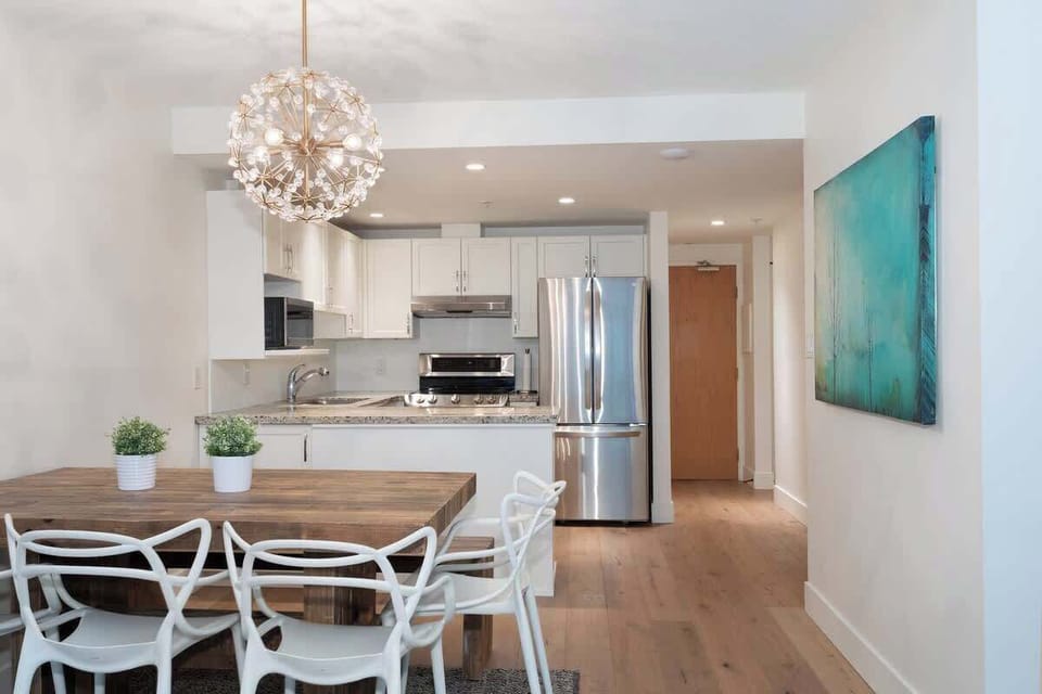 - Modern kitchen with stainless steel appliances and marble countertop style  
- Rustic wood dining table with chic chairs for warm alpine dinners  
- Open layout connects cooking and dining for effortless entertaining  
