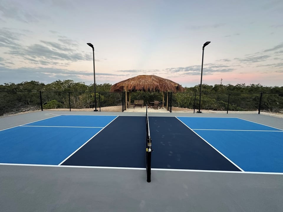 "Come join us for a game of PIckleball on our new Pickleball court. Set in a beautiful natural surrounding, with a shaded Tiki hut for breaks and court lights for evening play "